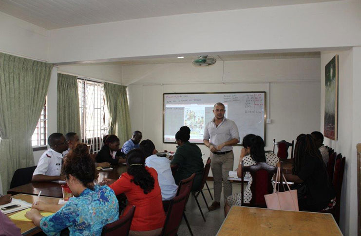 Professor Nelson Hernan Giraldo of the Universidad Del Norte, engages public servants during a lesson.