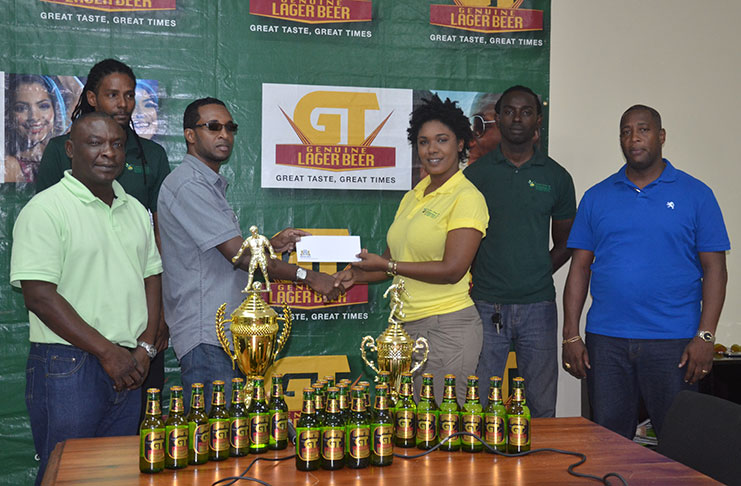 GT Beer Brand Manager Geoff Clement (third left) hands over the sponsorship to the Managing Director of Xtreme Clean and Maintenance Co., Shanai Gomes while the Banks DIH Events and Sponsorship Manager Mortimer Stewart (right) and Communication Manager Troy Peters (left),  Xtreme Clean officials Kester Gomes (second left) and Seraiah Clarke share the moment at Thirst Park yesterday.