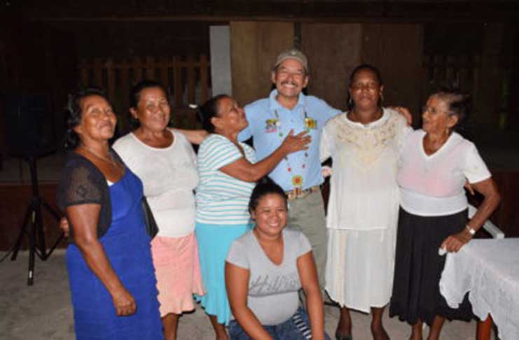 Vice-President and Minister of Indigenous People's Affairs Sydney Allicock, sharing a moment with some of the mothers of Moraikobai