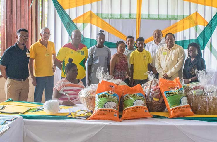 AFC leaders including Prime Minister Moses Nagamootoo, AFC Leader and Minister of Natural Resources, Raphael Trotman, Minister of Business Dominic Gaskin and MP, Audwin Rutherford pose with recipients of the donation