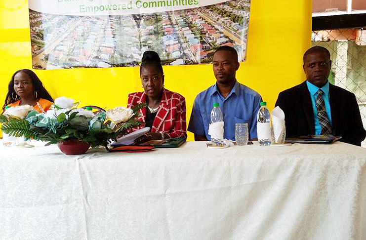 Minister Valarie Paterson (centre) sits at the head table with Mayor of Linden Carwyn Holland, CEO of CH&PA Lelon Saul (right) and CH&PA Region 10 staff member, Oletha Williamson (left)