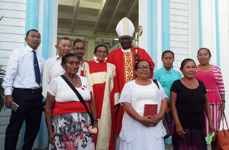 Newly ordained Deacon Rita Hunter and the Right Reverend Bishop Charles Davidson (in back row), pictured with her family members. From left in back row are:  Her son Rawle; husband Barrington; and at extreme right (back) is daughter Kathleen.