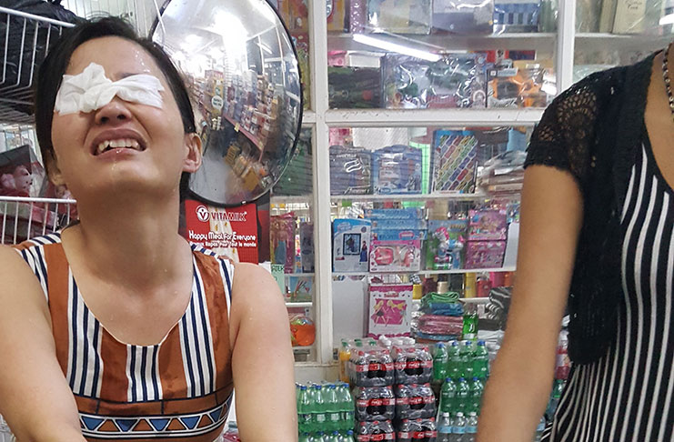 The female Chinese proprietor after she was sprayed with mace by one of the three alleged shoplifters