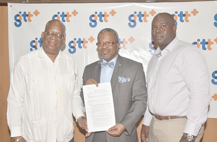 Following the signing Monday of the landmark GTT-UG deal, are, from left: Minister of Finance, Mr Winston Jordan;  Vice-Chancellor, Dr Ivelaw Griffith and Mr Justin Nedd