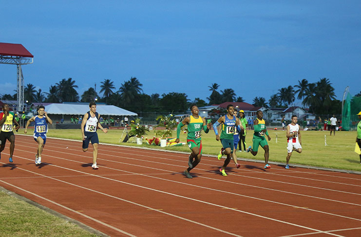 Compton Caesar fights hard against Brazil's Derick De Souza Silva to win the boy's 100m