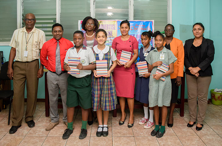 Four of the five Chronicle awardees. With them are, from left, Chronicle Circulation Consultant, Mr George Clarke; Marketing Coordinator, Mr Akash Persaud; Circulation’s Ms Kim Halley; Human Resources Officer, Ms Lynette Griffith; and General Manager, Ms Moshamie Ramotar