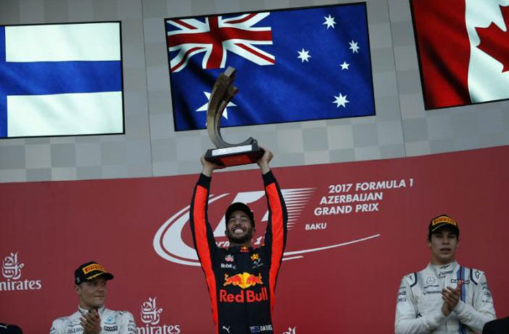 Red Bull Racing Formula One driver Daniel Ricciardo of Australia celebrates his victory over second placed Mercedes' Valtteri Bottas and third placed Williams' Lance Stroll. REUTERS/David Mdzinarishvili