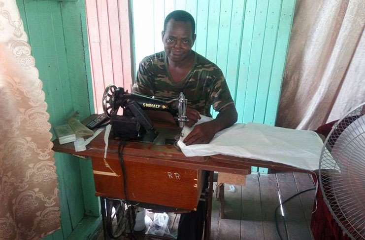 Mr. André Richards, hard at work, making  one of his shopping bags