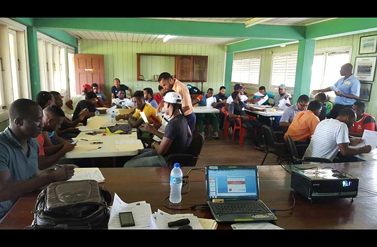 Nicholas Fraser of the Education Ministry’s Allied Arts Unit interacts with a few of the participants.