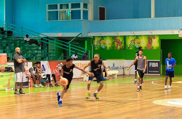 Head Coach Lugard Mohan (first from left), overlooking a scrimmage yesterday at the Cliff Anderson Sports Hall (Delano Williams Photo)