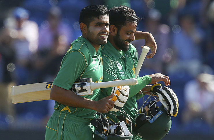 Pakistan’s Babar Azam and Mohammad Hafeez walk off victorious against England  in the first Champions Trophy semi-final