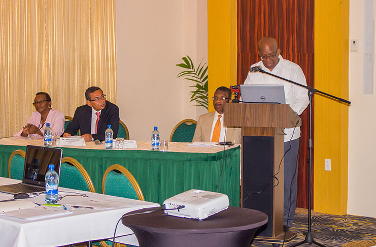 Minister of Finance, Winston Jordan, as he addressed the workshop. 
Seated from left are : Donna Yearwood, Head, Debt Management Unit, Ministry of Finance; Jaime Coronado Quintanilla, Coordinator of CEMLA'S Public Debt Management Capacity Building Programme; and Dr Terrence Smith, Deputy Governor of the Bank of Guyana.
