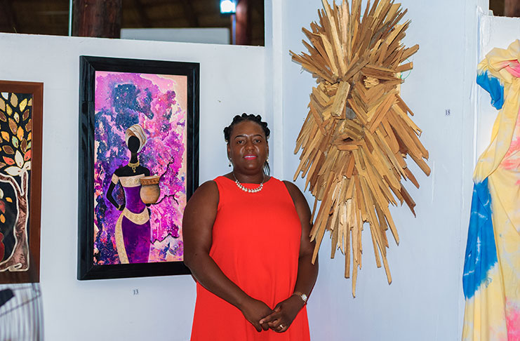Aelisha Garnett-Williams and her pieces entitled “Behind the Mask” (right) and Mother of the Universe
