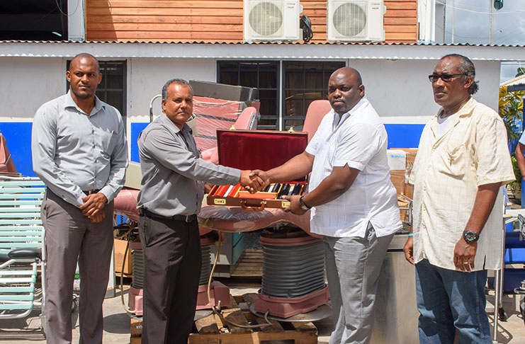 FFTP Chief Executive Officer, Mr. Kent Vincent (centre left), makes the  symbolic presentation to the Region Six Director of Health Services, Jevaughn Stephens). Looking on at extreme left is, Senior Manager, ‘Gifts in Kind Department,’ Jimmeel Davis and at extreme right is Alex Foster, Focal Point Co-ordinator, Min. of Public Health (Samuel Maughn photo)