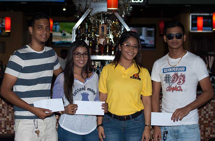 Superbike Rider Raveiro Tucker (left) poses for a photo opportunity with street tuner competitor Sharima Khan, Palm Court Events Manager Sasha Lewis and fellow rider Kevin Persaud. (Delano Williams photo)