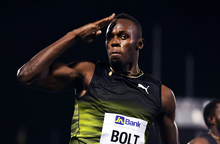 Usain Bolt salutes the crowd as he crosses the finish line of his final race in his home country on Saturday night. (Photo: AFP)