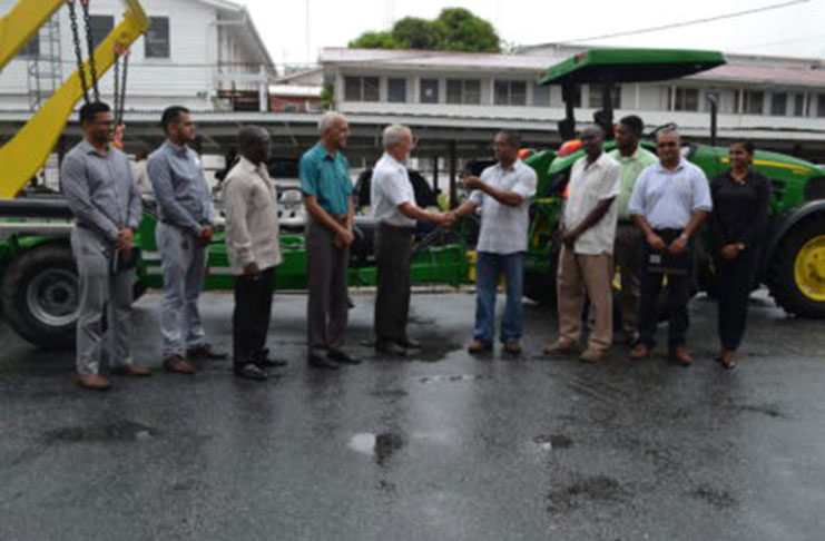 L-R Permanent Secretary of the Ministry of Communities, Emil Mc Garrell; Minister of Communities, Ronald Bulkan; Genequip Chief Executive Officer (CEO), Renger Van Dyk hands over the keys to the Region Eight Regional Executive Officer (REO) (ag), Gavin Gounga, and other officials