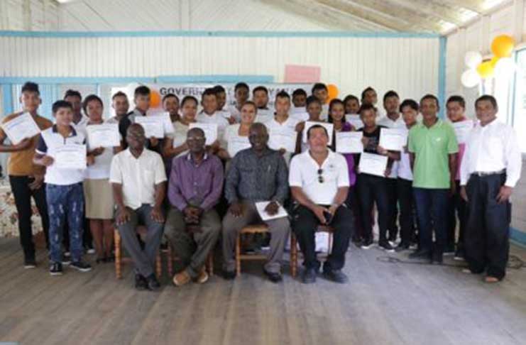 BIT Technical Officer, Richard Maughn, Officials from BIT, Toshaos, David Henry and Graduates from Orealla and Siparuta