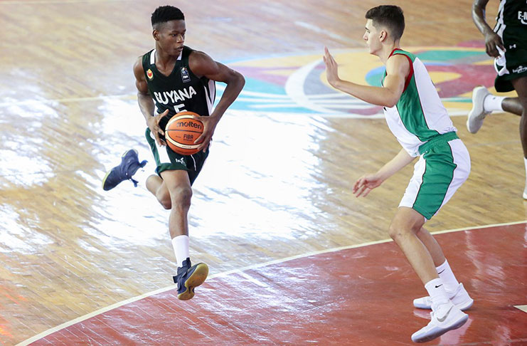 Guyana’s Nigel Bowen powers his way to the basket to score two of his 21 points against Mexico yesterday in the Dominican Republic. (Photo compliments: FIBA)