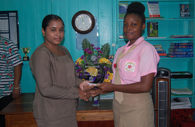 First-place winner Brianca Michaels, receiving her plaque from Demerara Bank representative, Ms Amrita Wailoo