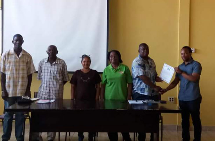 Member of Parliament Mr Jermaine Figueira (right) handing over a certificate of participation to Group Treasurer, Mr Kevin De Jonge. With them are, from left, Mr William Issacs, Mr Zeonard Skeete, Ms Anna Bridglall, and Ms Sheena Bristol