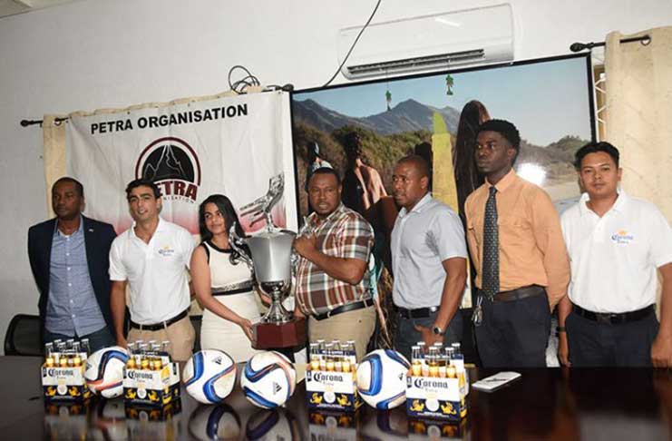 Flashback:Top Brandz  Sales and Marketing Manager, Pratima Prashnajeet and Petra Co-Director, Troy Mendonca hold a replica of the championship trophy in the presence of GFF president, Wayne Forde (far left), GFA vice-president Aaron Fraser (3rd from right) and other company representatives at the launch of the tournament