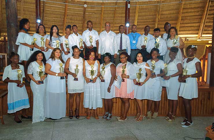 The best-graduating, most improved and persevering students gathered to take a picture with Finance Minister, Winston Jordan
