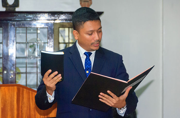 Justice Gino Persaud takes the oath of office while being sworn in as a judge on Wednesday by President David Granger