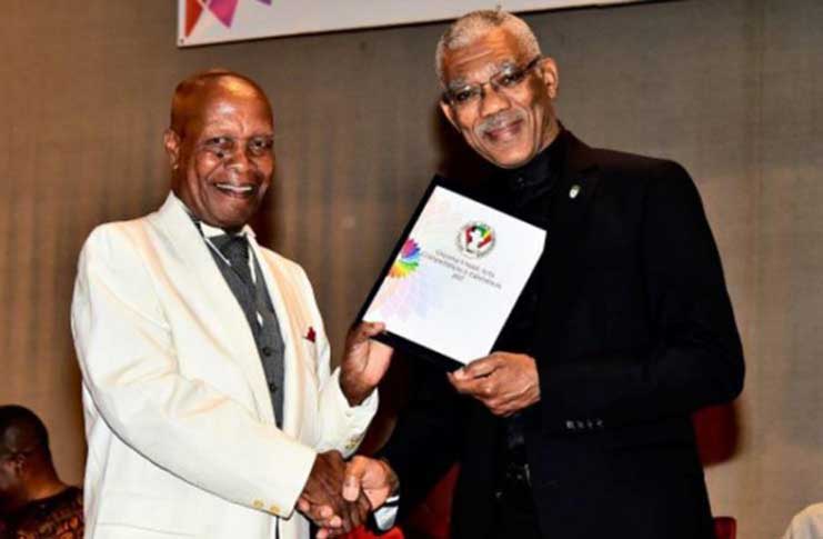 President David Granger
presenting the Guyana Visual Art Competition’s Lifetime Achievement Award to Jorge Bowen-Forbes at the National Cultural Centre, recently (Samuel Maughn Photo)