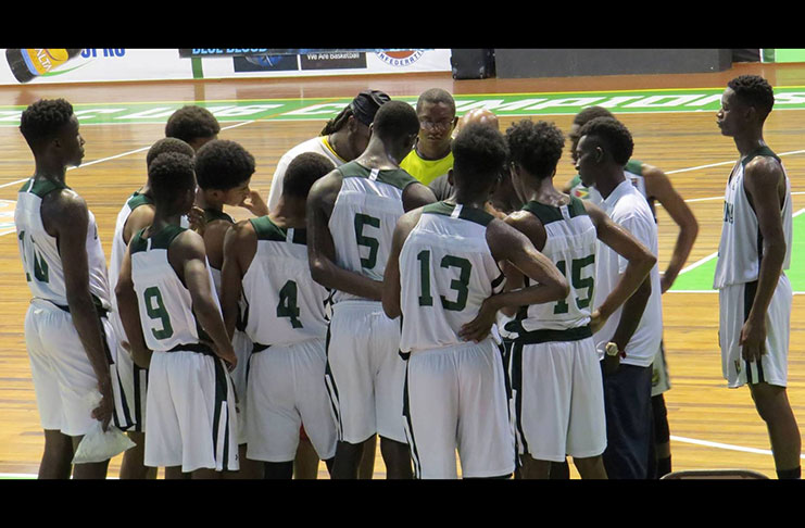 Team Guyana in a huddle during one of their practice games at the Cliff Anderson Sports Hall recently.