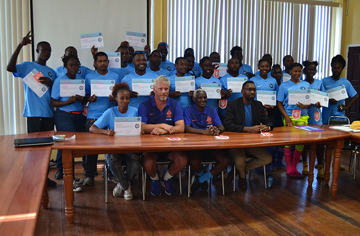 Andre Simmelink, who works with the Royal Dutch Football Association (KNVB) in the Netherlands and Surinamese Mr Kenneth Jaliens joined Sport Director Christopher Jones and the participants of the five-day workshop for a photo..