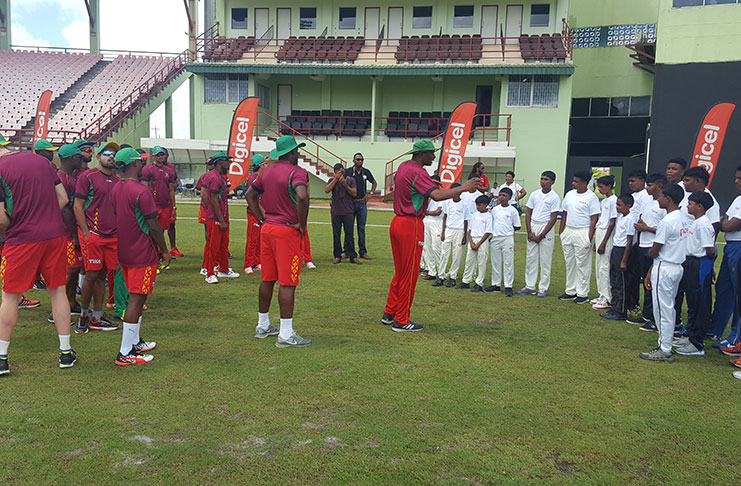 Head Coach Roger Harper having a chat with the youths before the start of the session.