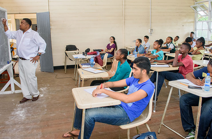 Dr. Terrence Blackman explaining a mathematical theory to the young maths enthusiasts