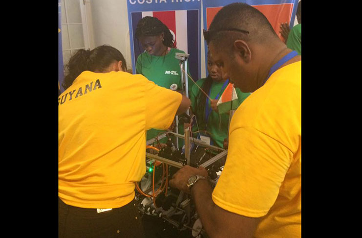 STEM Guyana members assisting another team with their robot