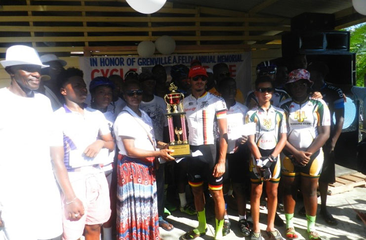 Paul DeNobrega poses with his trophy, flanked by other riders, and sponsor with trophy in hand. (Colin Bynoe photo)
