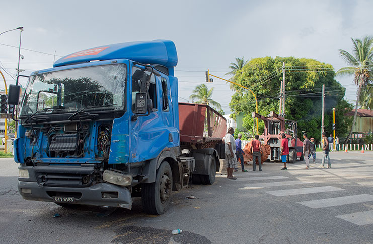 The paddy-laden truck which flipped on its side after it collided with a motor lorry, killing two cows and injuring two persons (Samuel Maughn Photo)