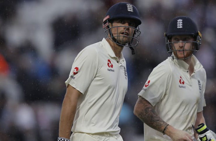 Alastair Cook and Ben Stokes leave the field as rain stops play. (Photo: Tom Jenkins for the Guardian)