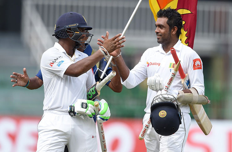 Dilruwan Perera and Asela Gunaratne celebrate after steering Sri Lanka to victory on day 5  in Colombo.