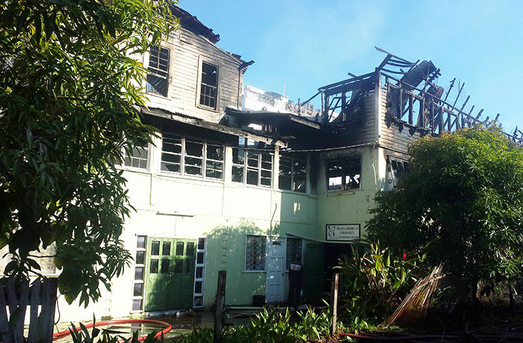 A fire early Tuesday morning destroyed a three-storey building owned by Working People’s Alliance (WPA) activist,
Ms. Joycelyn Dow at 172 Charlotte Street, Georgetown and left a trail of destruction in its path (Delano Williams
photo)