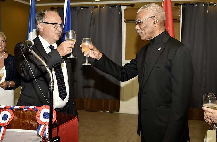 President David Granger and French Ambassador to Guyana, Mr. Antoine Joly share a toast in celebration of France’s National Day and good relations between the two countries