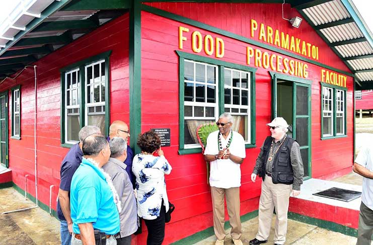 President David Granger listens as Minister within the Ministry of Indigenous People’s Affairs reads
out the inscription on the plaque, which he had just unveiled to officially commission the Paramakatoi
Tomato Project Facility. Also in the photograph are to the President’s left Canadian High Commissioner
to Guyana, Pierre Giroux. Partially obscured are Minister of Indigenous People’s Affairs, Sydney Allicock,
Minister within the Ministry of Finance, Jaipaul Sharma and Minister of Business, Dominic Gaskin
(Ministry of the Presidency photo)