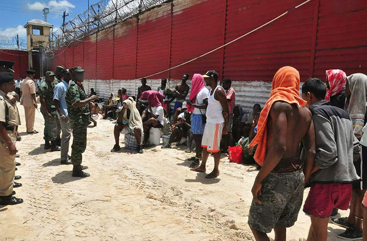 Chief-of-Staff of the Guyana Defence Force, Brigadier, Patrick West engages prisoners who were
relocated to the Brick Prison at the Camp Street facility on Tuesday( GDF Photo)