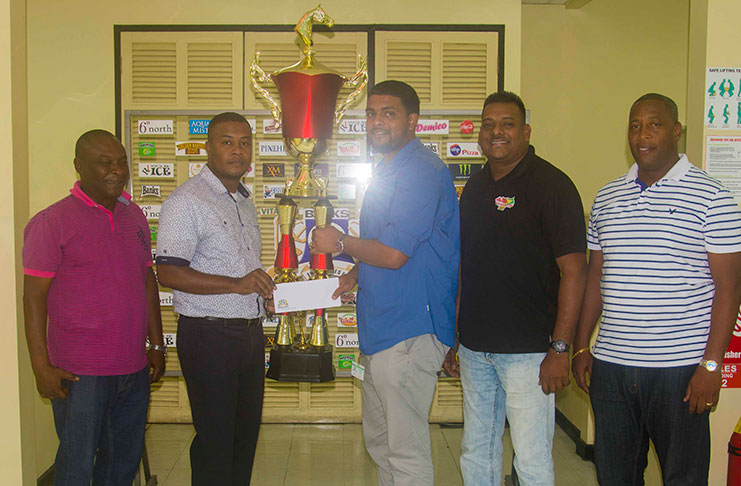 Rawle Nedd (Banks Beer Trainer Manager) (second left) presents the sponsorship package to Nasrudeen Junior Mohamed (Guyana Cup Promoter) while Troy Peters (Communications Manager, Roy Jafarally (Race Organiser)  and Mortimer Stewart (Outdoor Events Manager) look on.