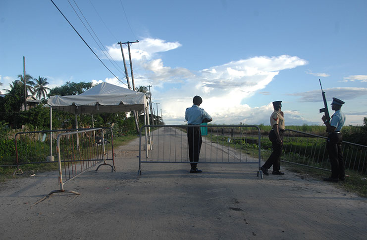 Officers stand at a barricade not far from the Lusignan Prison