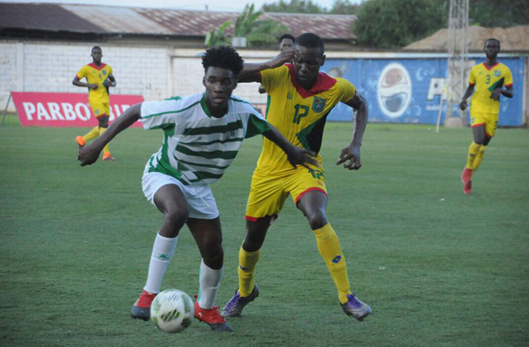 Part of the action between Guyana and Suriname at the Franklin Essed Stadium, yesterday (Delano Williams photo)