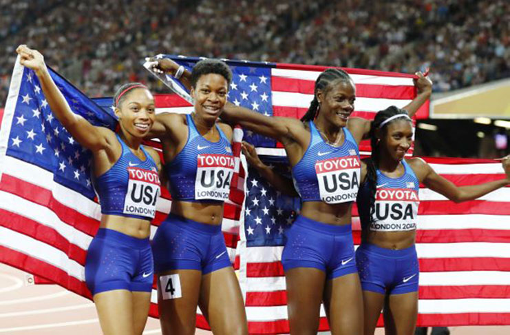 Members the U.S. relay team celebrate after winning the 4x400m relay gold medal.