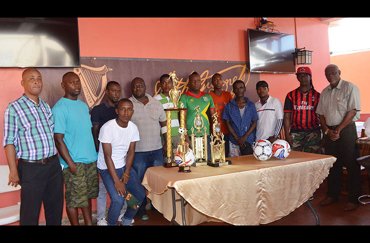 Organisers and competing teams pose at yesterday’s launch of the Guinness Cage Football Championship at the Windjammer Hotel.