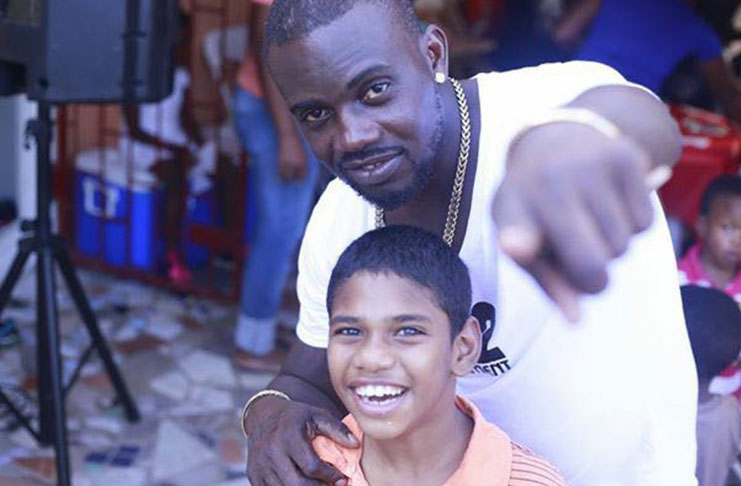 The sensational performer/singer Jumo Primo with a fan at his birthday fete for children