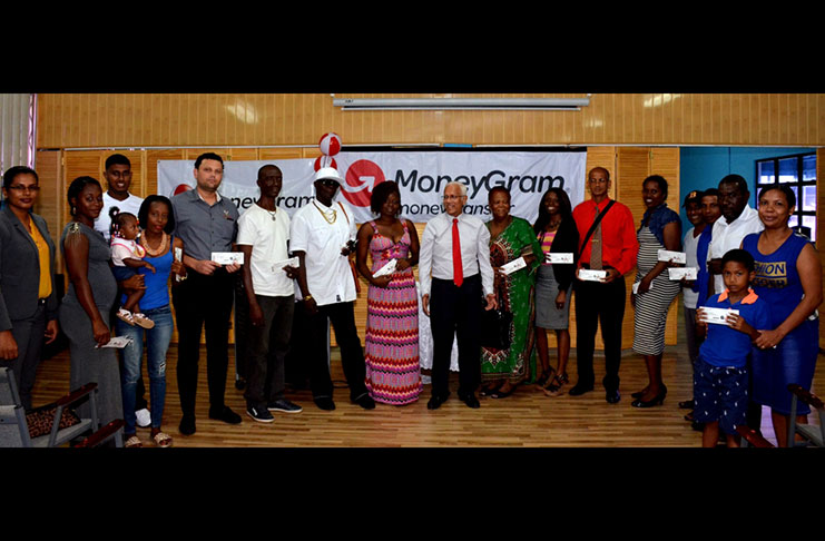 Deo Persaud, Chairman of the Massy Guyana Group of Companies joins winners of the MoneyGram CPLT20 2017 promotion.