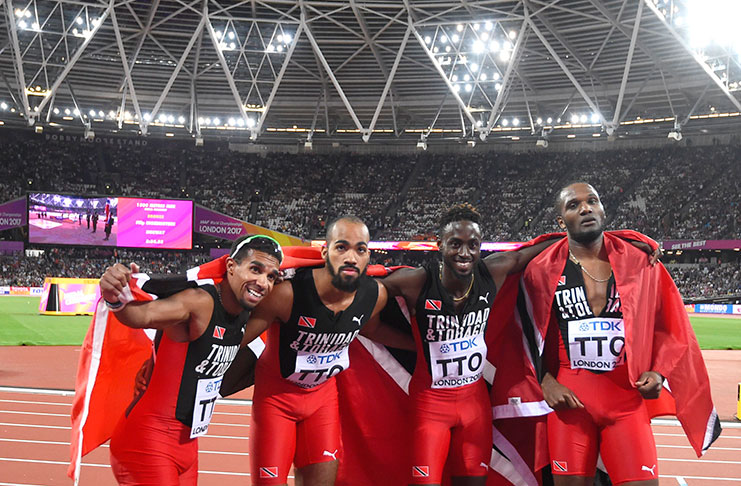 Members of Trinidad and Tobago relay team celebrate after winning the gold medal.